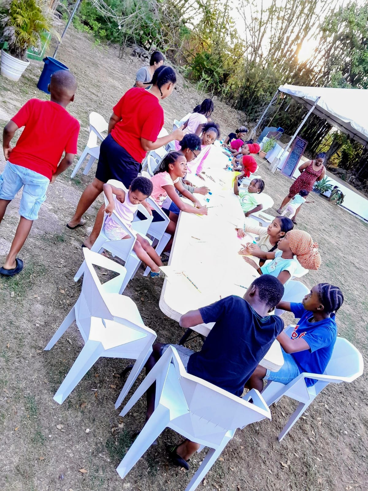 Children engaging in arts and crafts activities outdoors at an Arouca Soul Kitchen program Children engaging in arts and crafts activities outdoors at an Arouca Soul Kitchen program